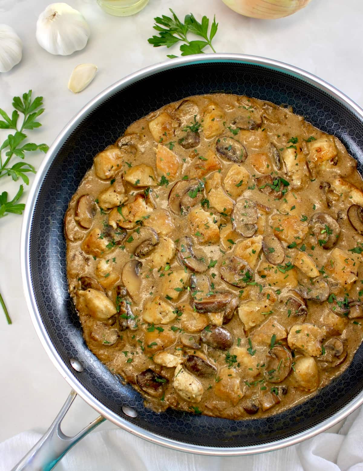 overhead view of Chicken Stroganoff in skillet with fresh parsley