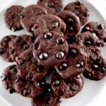 Chocolate Coconut Brownie Bites stacked on white plate