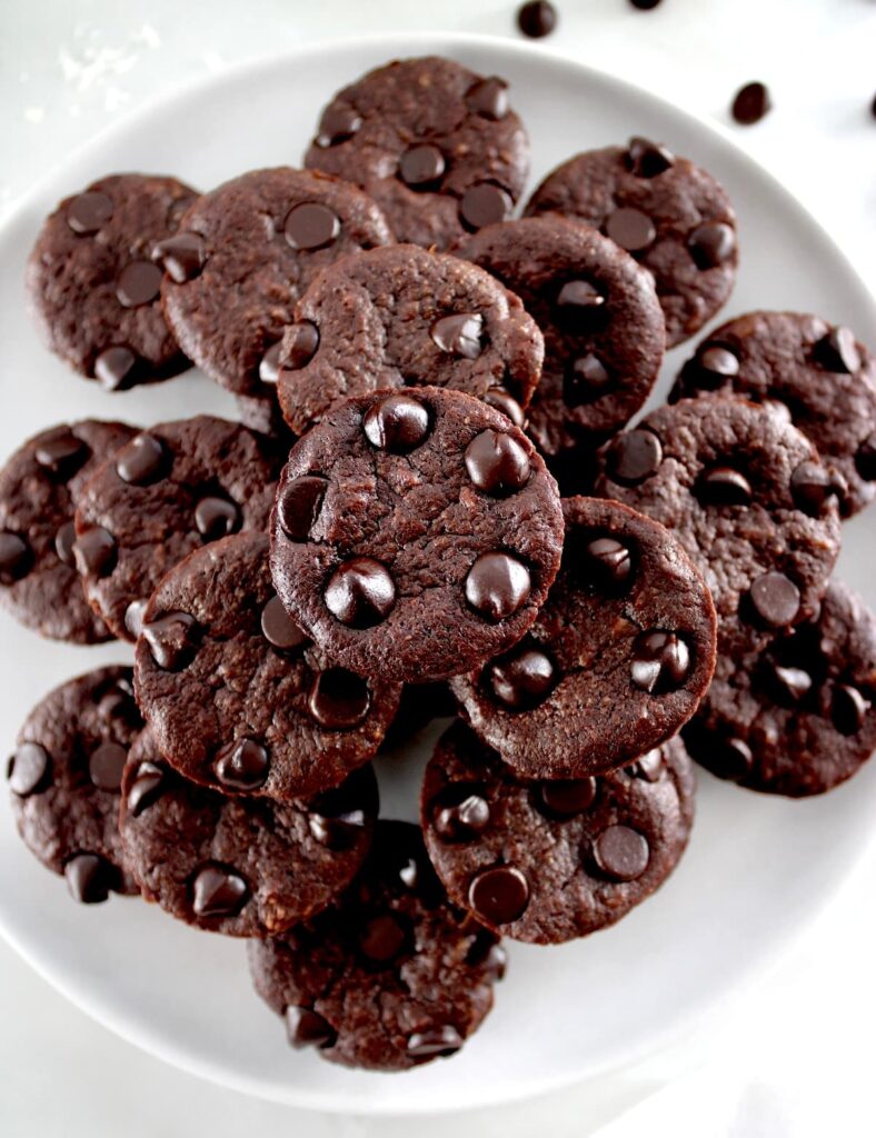 Chocolate Coconut Brownie Bites stacked on white plate