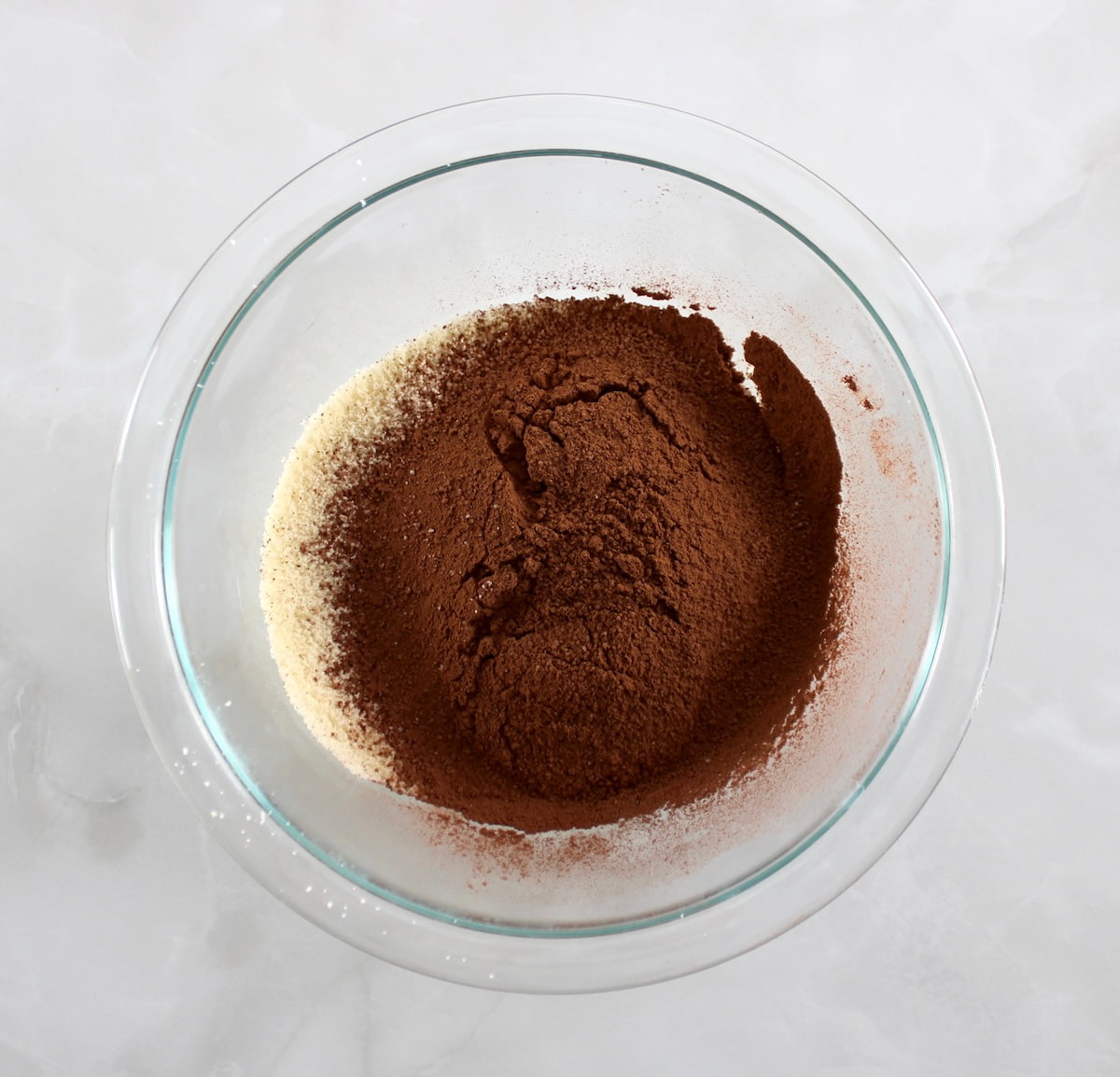almond flour and cocoa powder in glass bowl unmixed