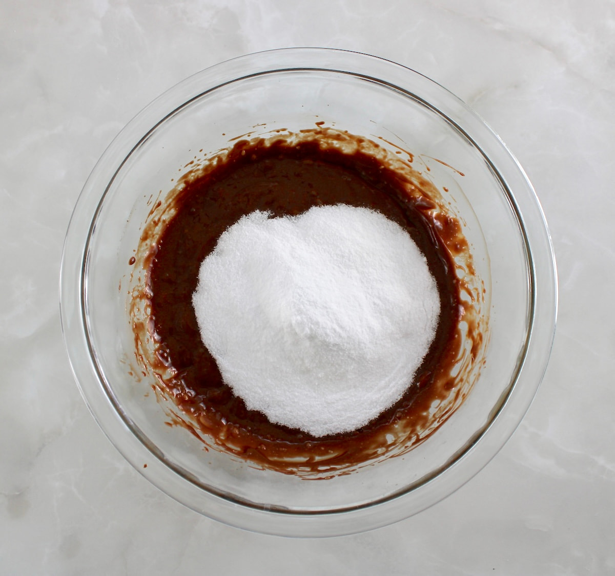 melted chocolate and sweetener in glass bowl unmixed