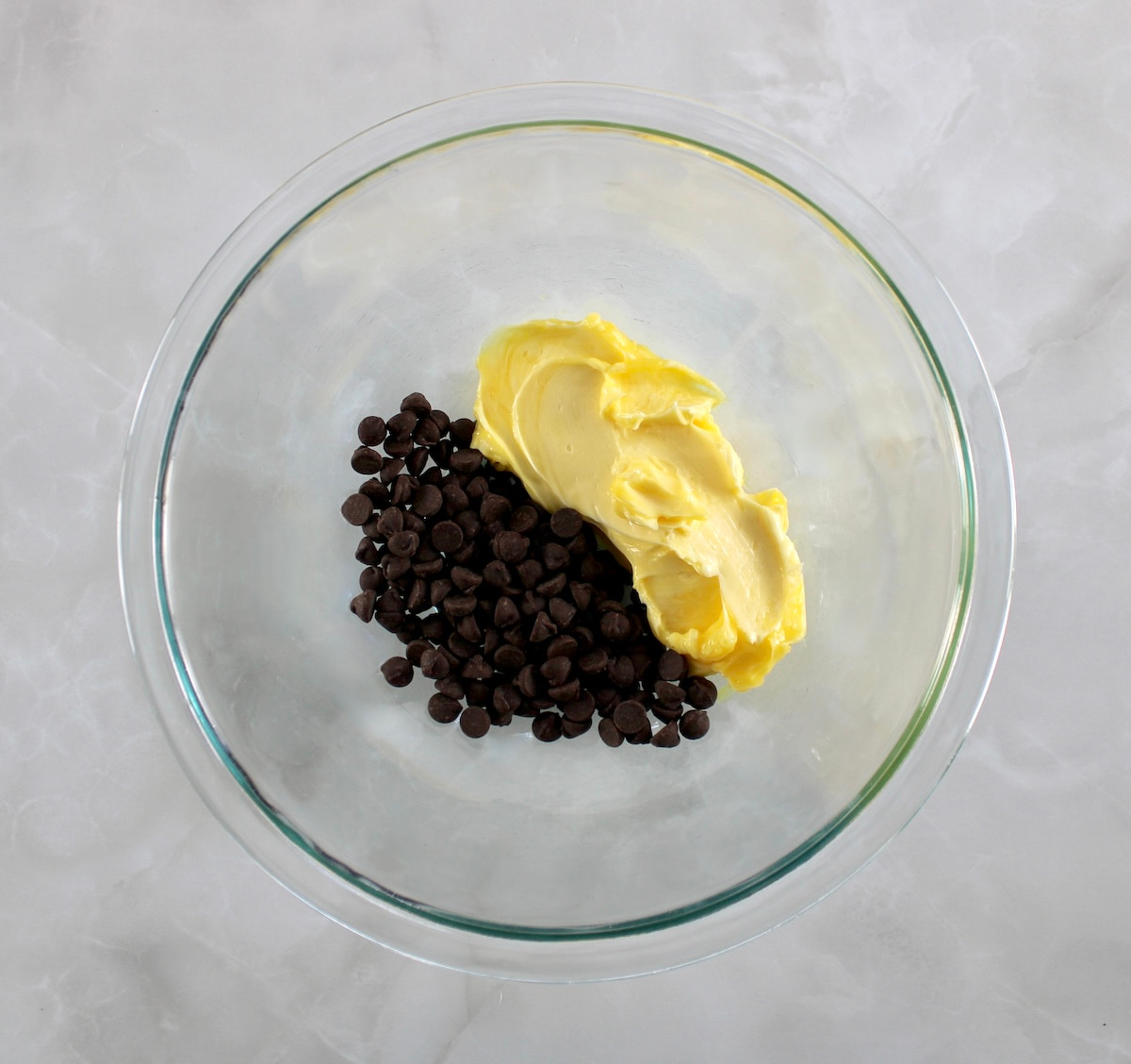 butter and chocolate chips in glass bowl