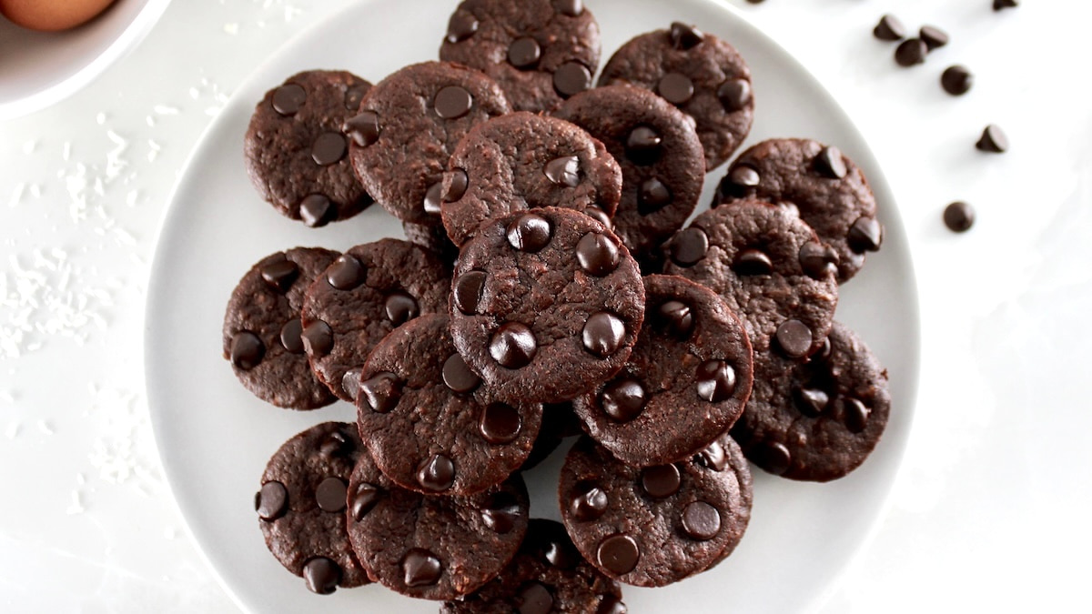 overhead view of Chocolate Coconut Brownie Bites stacked on white plate
