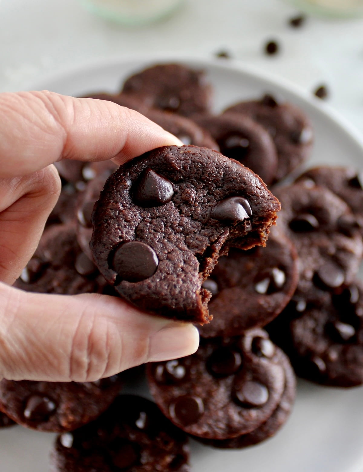 closeup of holding Chocolate Coconut Brownie with bite missing