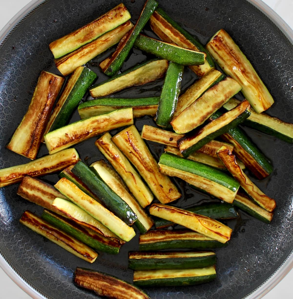 sautéed zucchini sticks in skillet