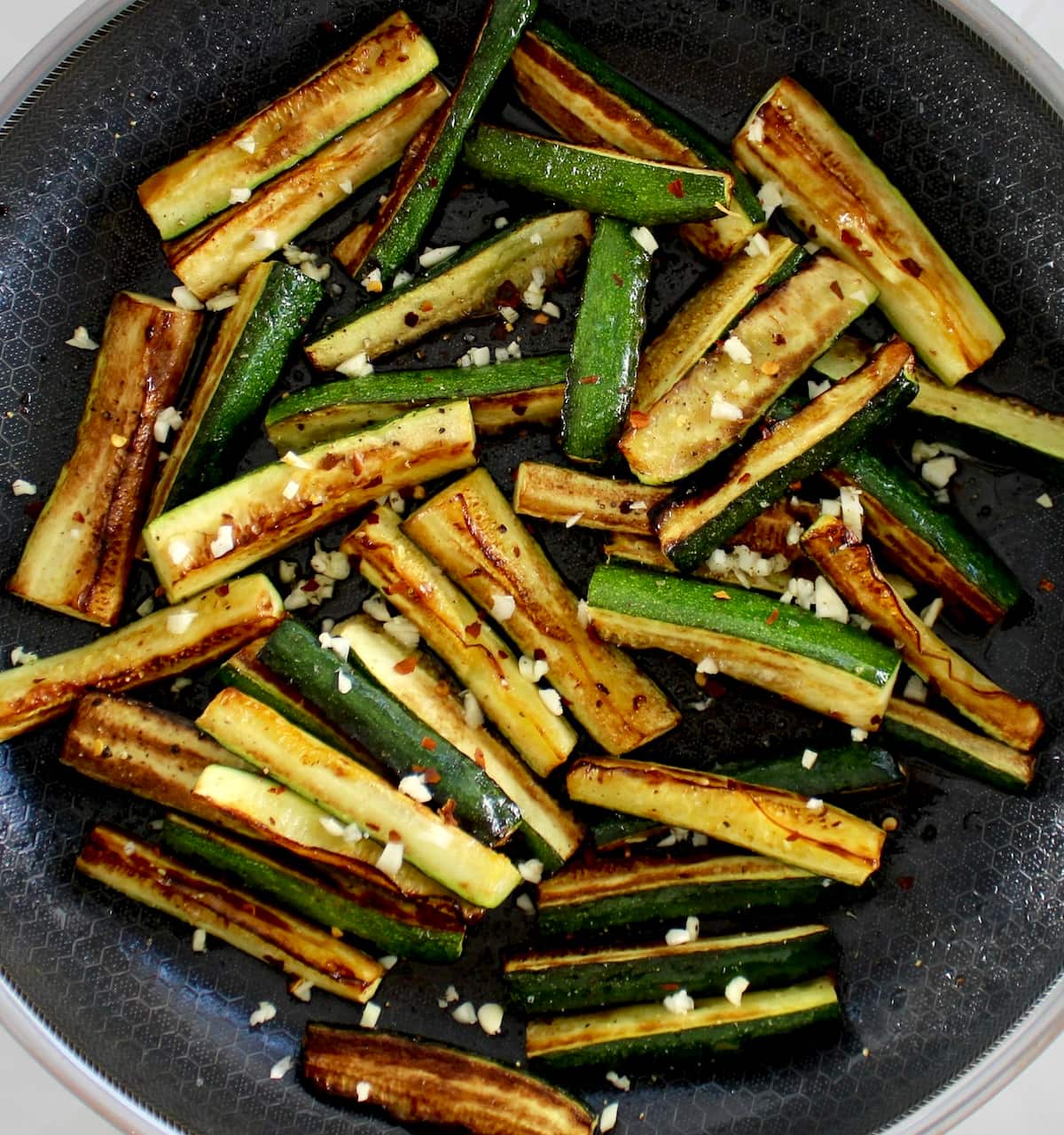 Easy Sautéed Zucchini with minced garlic in skillet