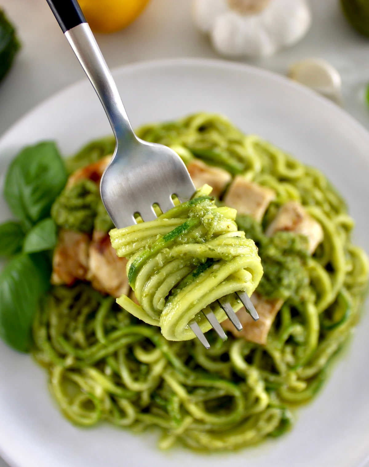 Grilled Lemon Chicken Pesto Zoodles with zoodles wrapped around fork