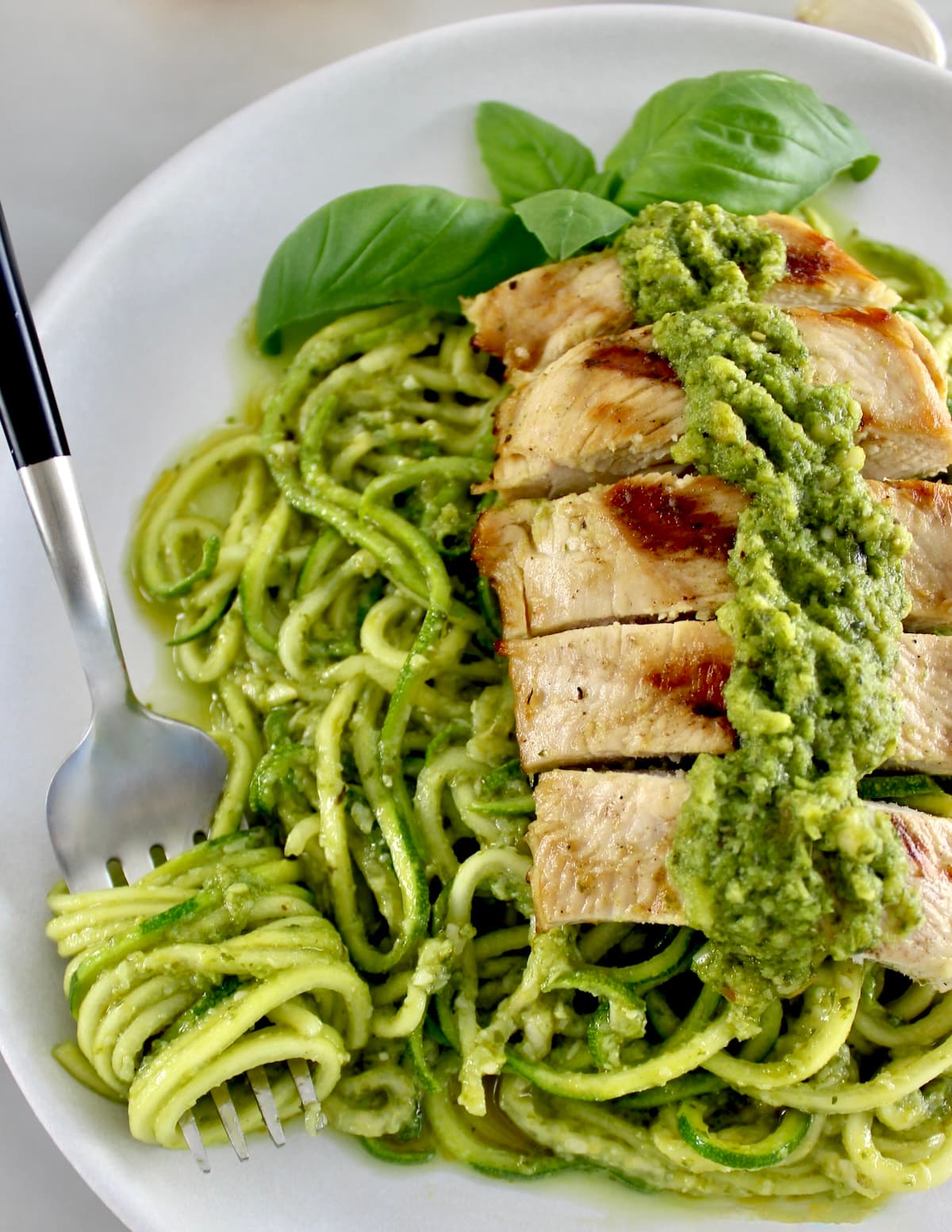 Grilled Lemon Chicken Pesto Zoodles with zoodles wrapped around fork