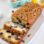 Keto Blueberry Crumb Loaf on white plate with 2 slices cut