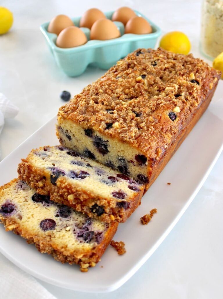 Keto Blueberry Crumb Loaf on white plate with 2 slices cut