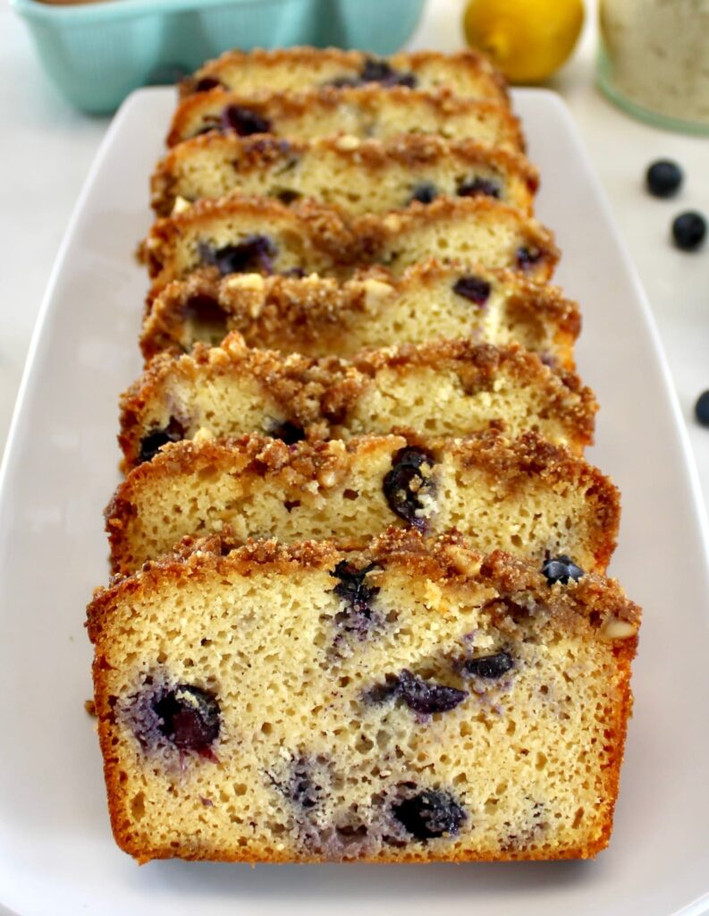 closeup of sliced Keto Blueberry Crumb Loaf on white platter