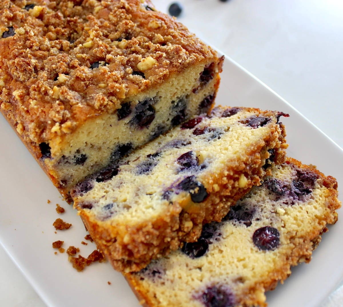 closeup of Keto Blueberry Crumb Loaf with 2 slices cut