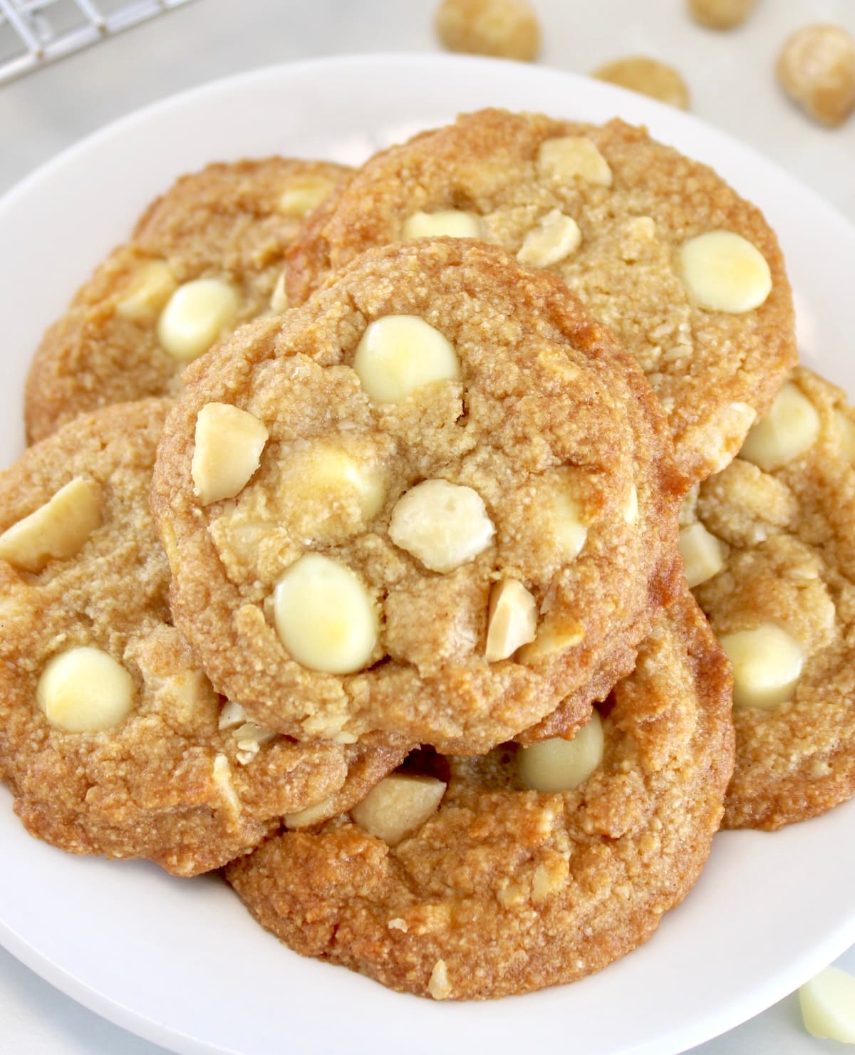 closeup of Keto White Chocolate Macadamia Nut Cookies on white plate