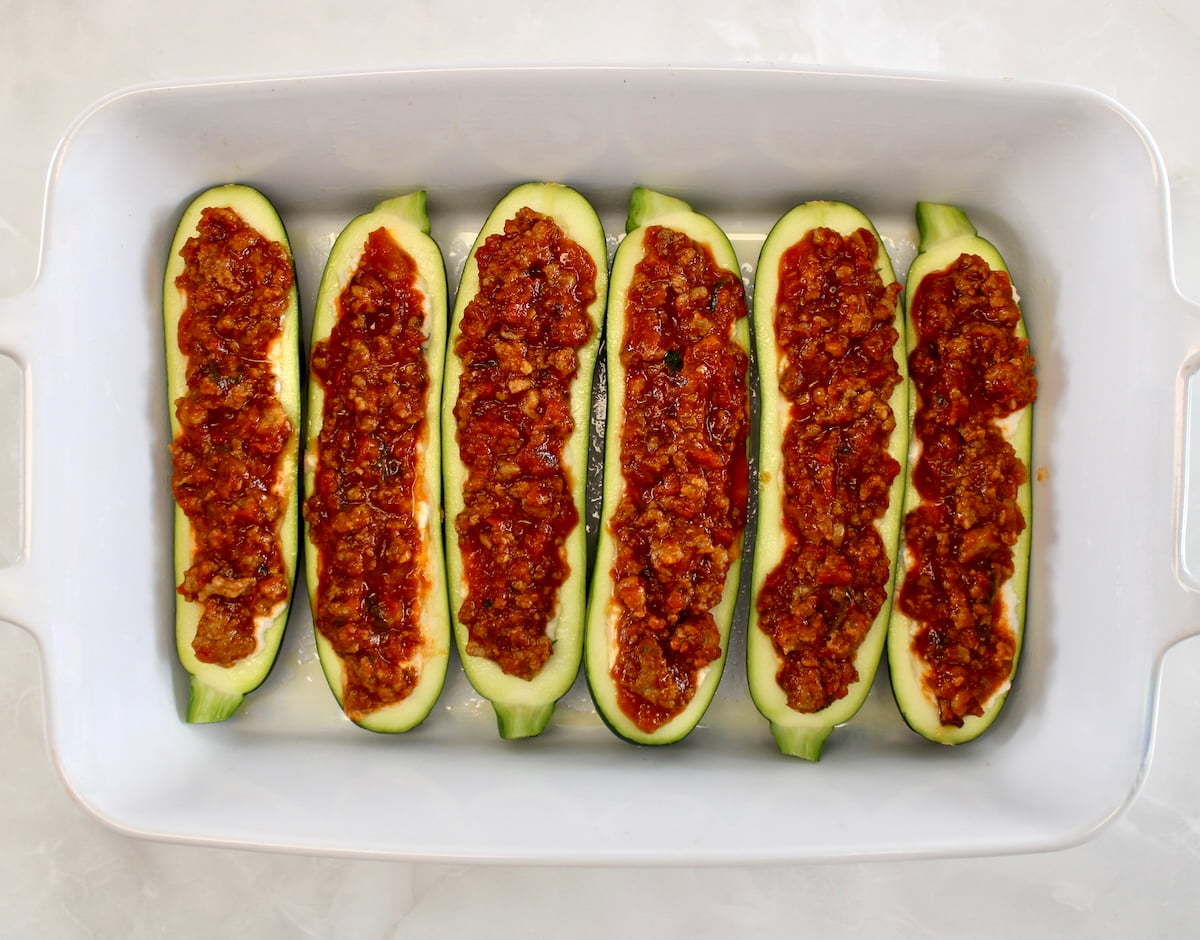 6 Lasagna Stuffed Zucchini Boats unbaked in white casserole