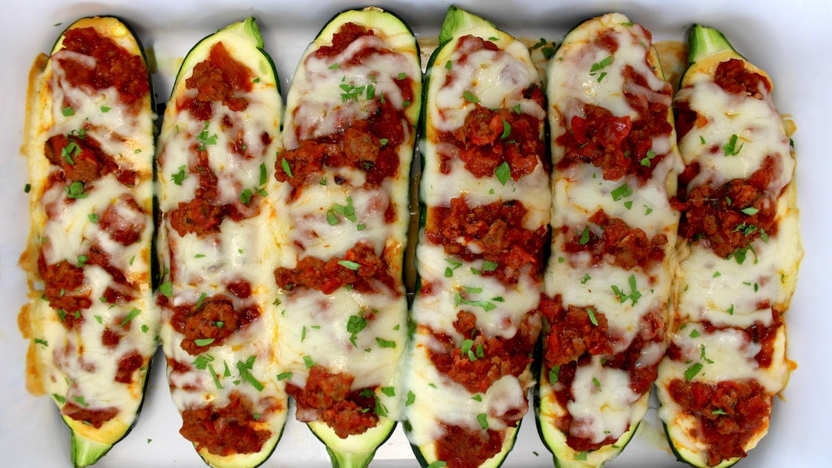 6 Lasagna Stuffed Zucchini Boats in white casserole