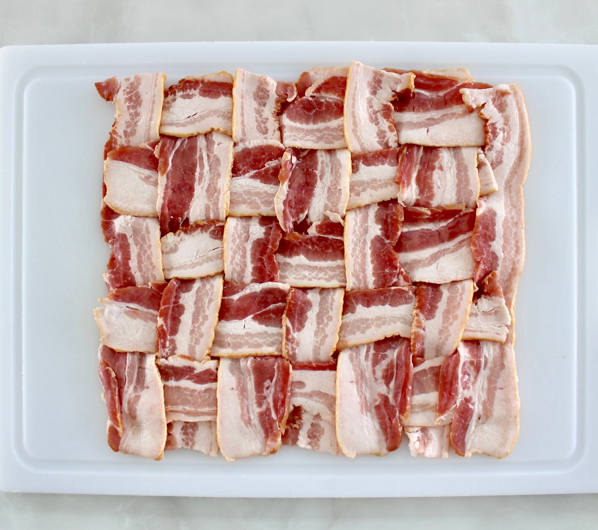 bacon weave on white cutting board