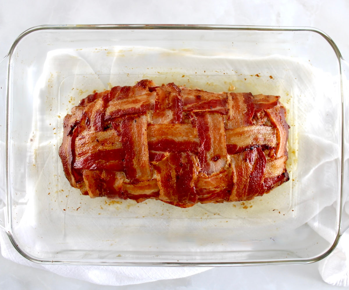 Bacon Wrapped Cheese Stuffed Italian Meatloaf in glass casserole dish