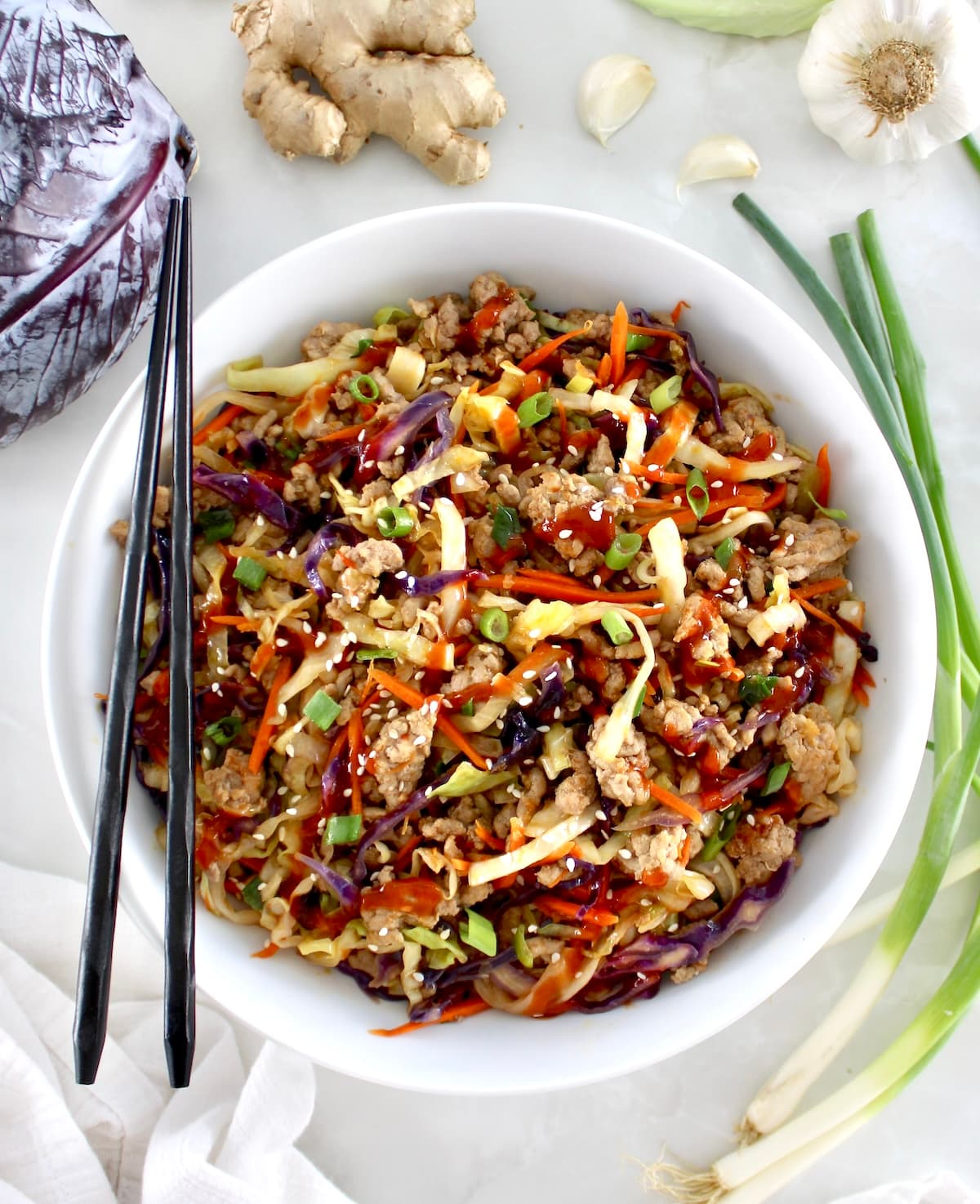 overhead view of Keto Egg Roll in a Bowl in white bowl with black chopsticks on side
