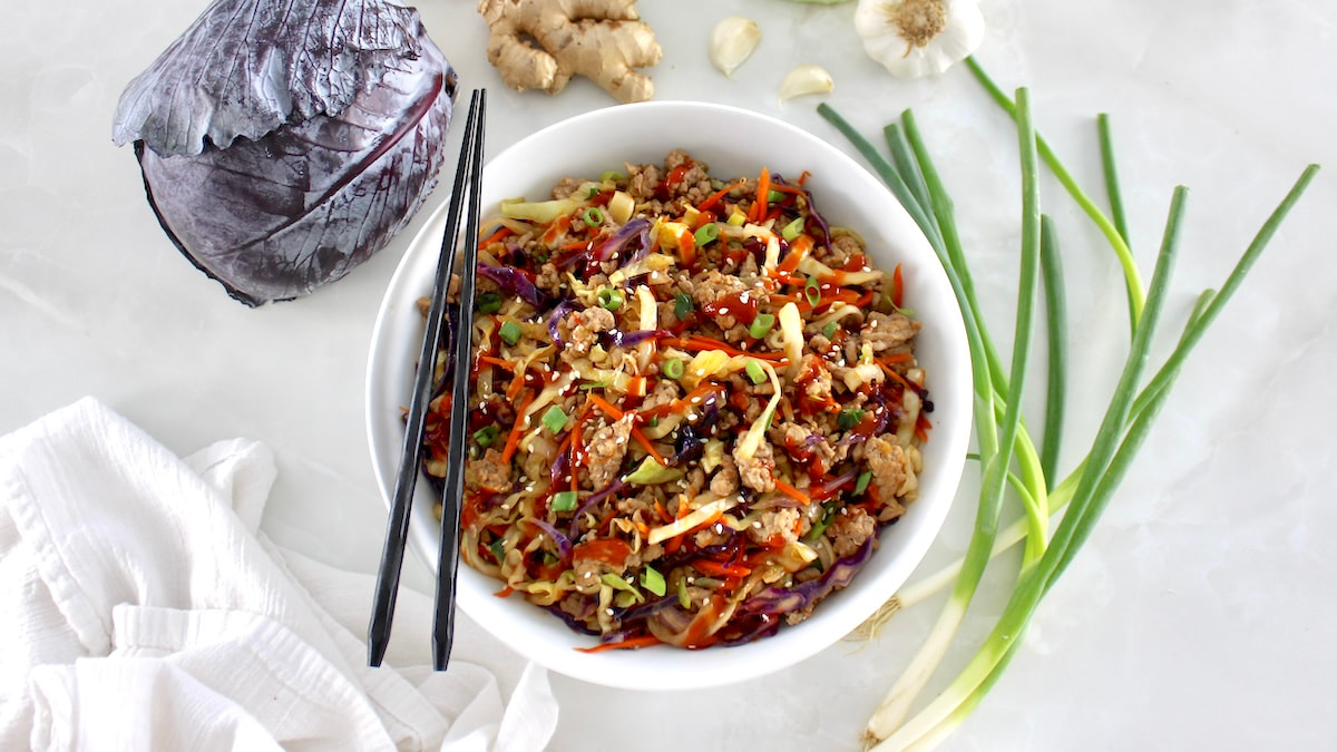 overhead view of Keto Egg Roll in a Bowl in white bowl with black chopsticks on side