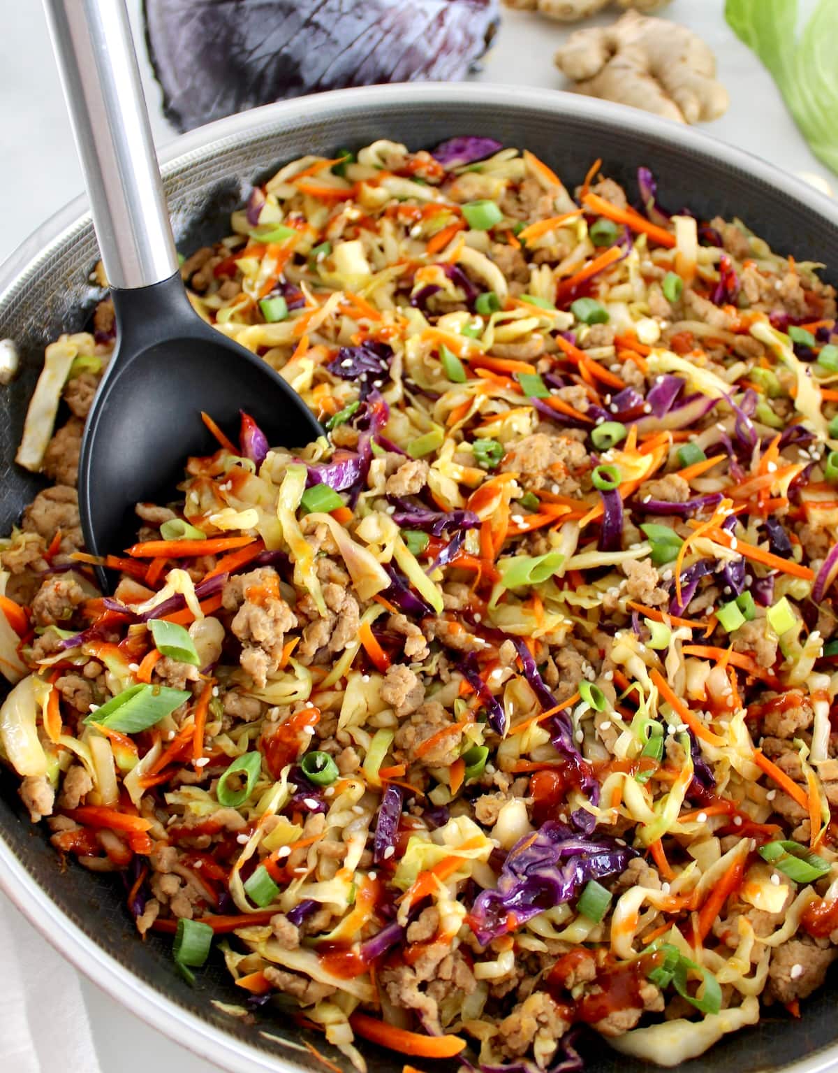 closeup of Keto Egg Roll in a Bowl in skillet with black serving spoon