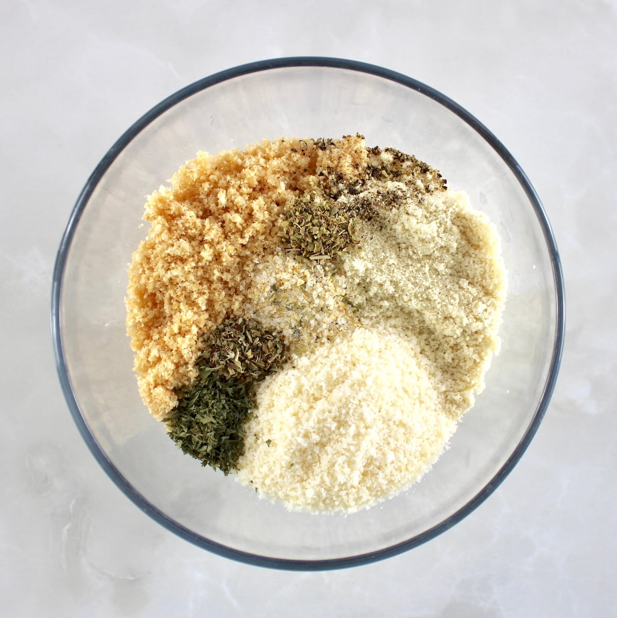 Keto Mozzarella Sticks breading mixture in glass bowl unmixed