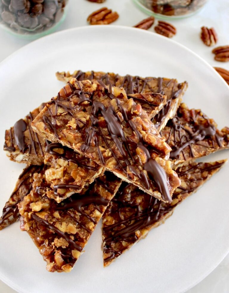 Keto Pecan Praline Bark pieces stacked up on white plate