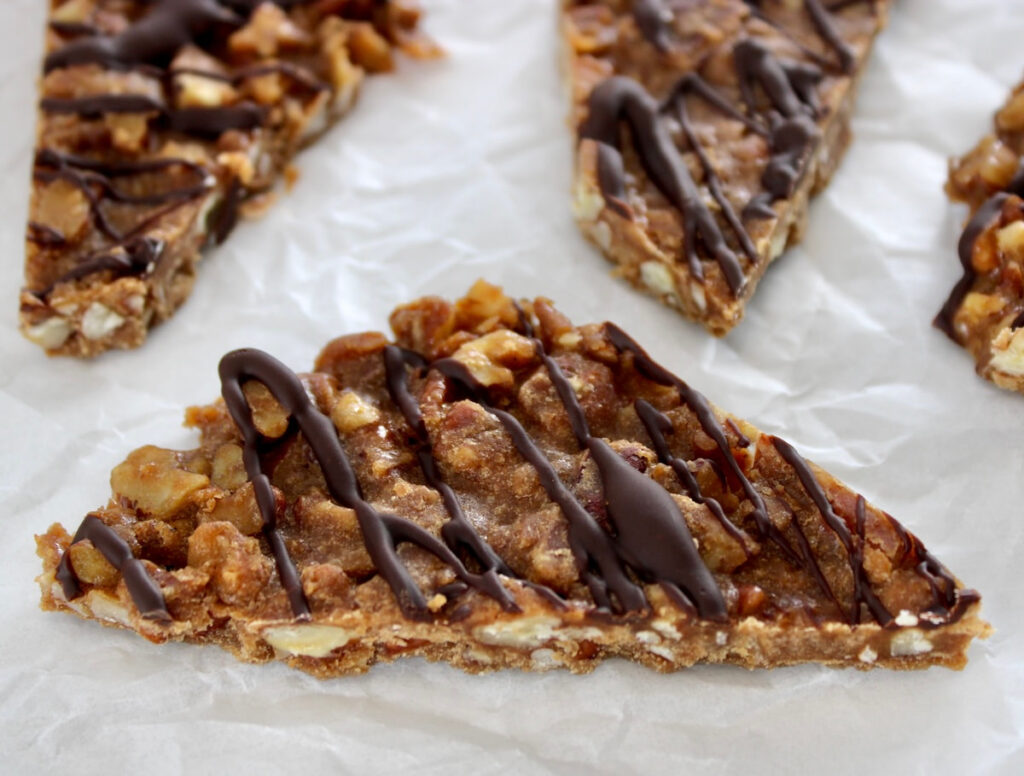 closeup of Keto Pecan Praline Bark on white parchment paper