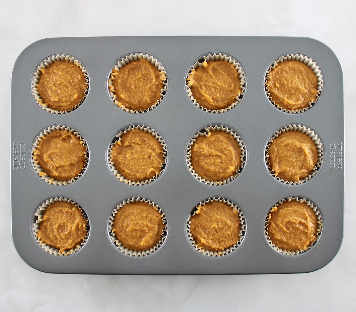 pumpkin muffins batter in 12 muffin liners