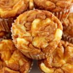 closeup of Keto Pumpkin Cream Cheese Swirl Muffins stacked up