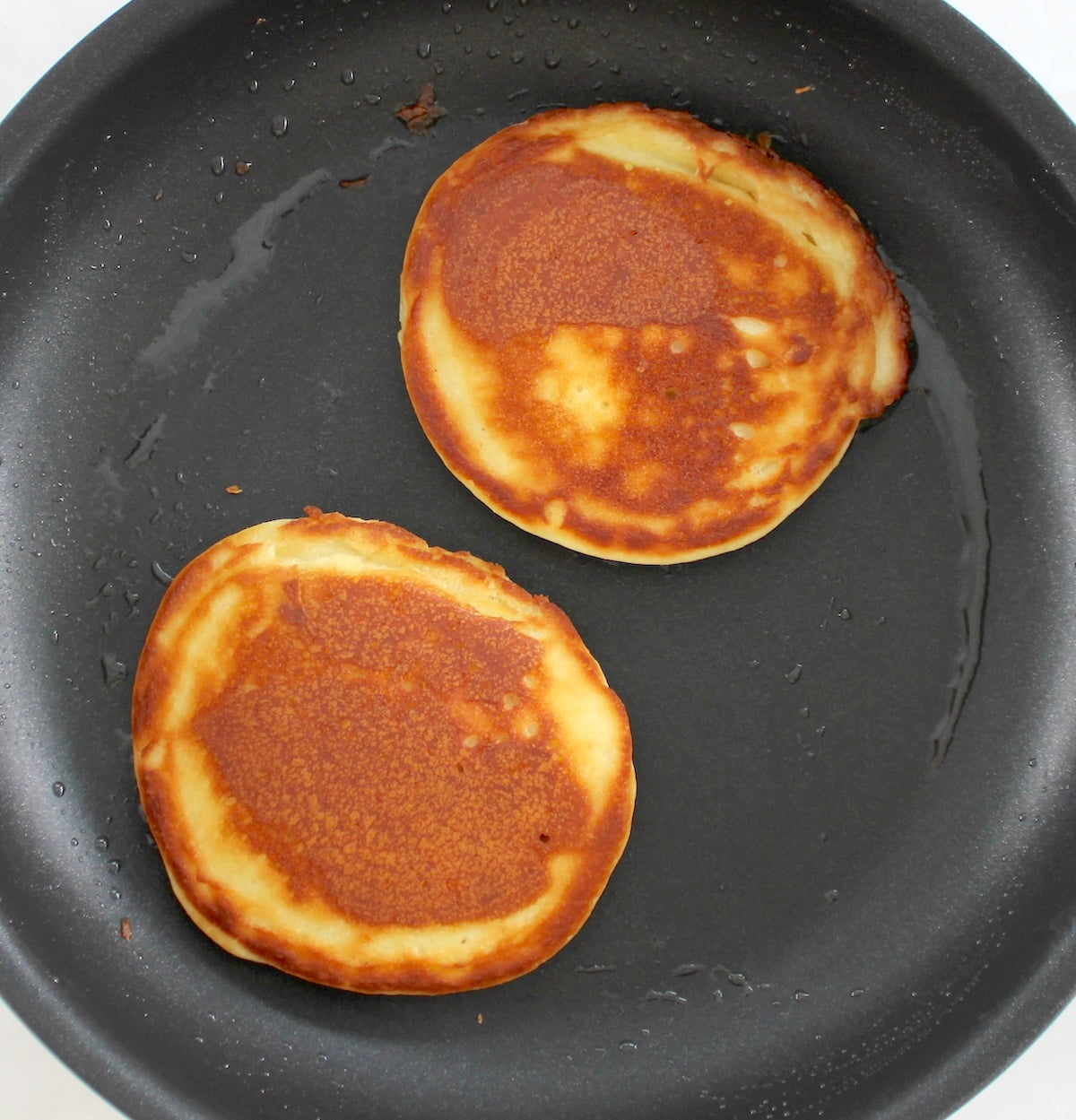 2 cooked Keto Tiramisu Pancakes in skillet