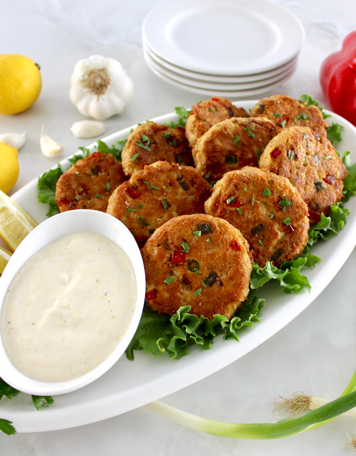 Tuna Cakes on white platter with garlic aioli on side
