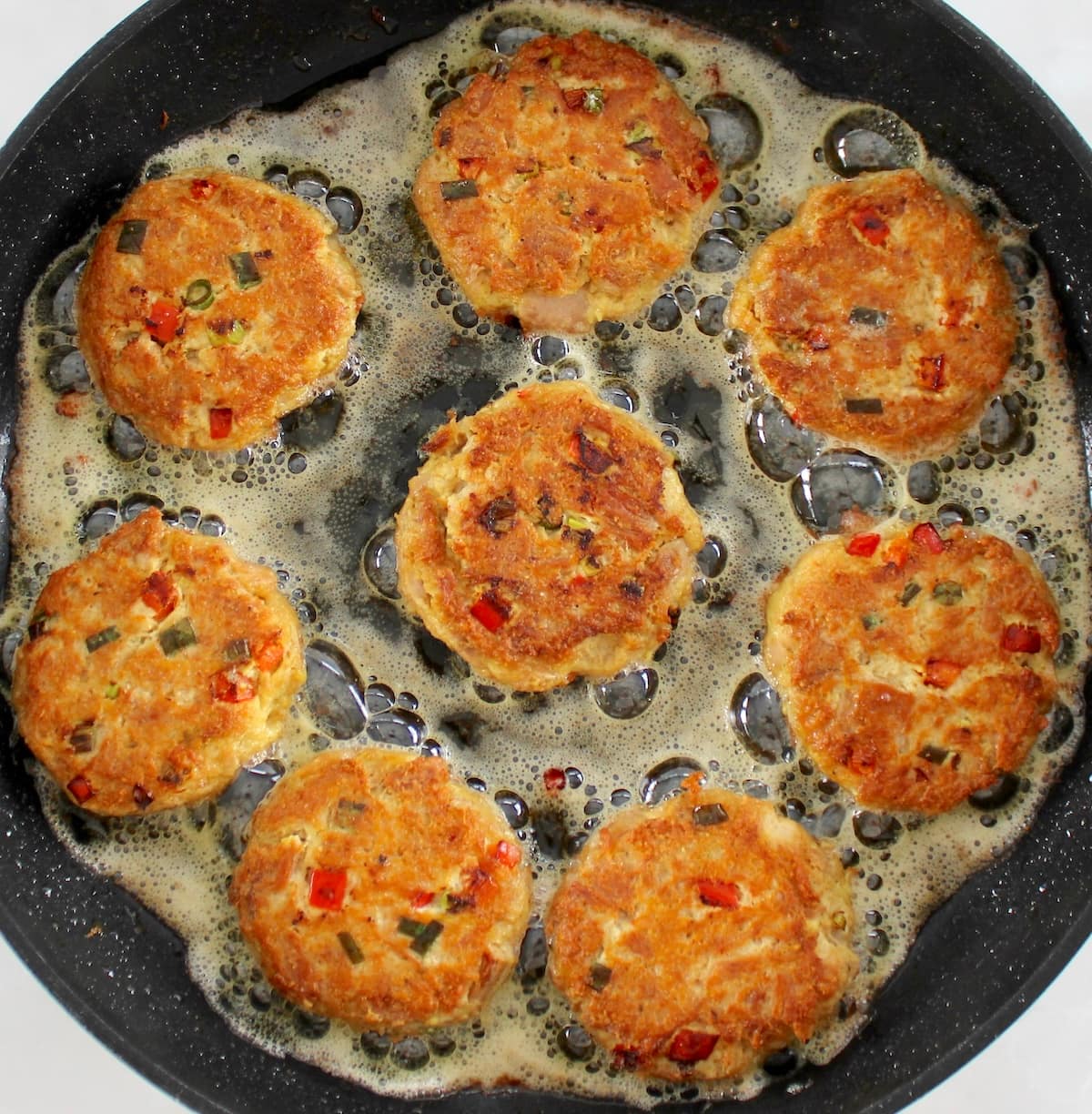 8 Tuna Cakes cooking in skillet