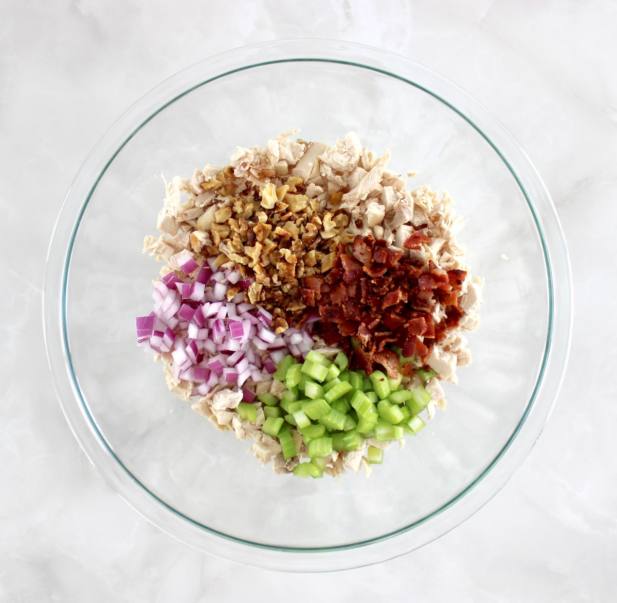 Bacon Honey Mustard Chicken Salad ingredients in glass bowl unmixed in sections