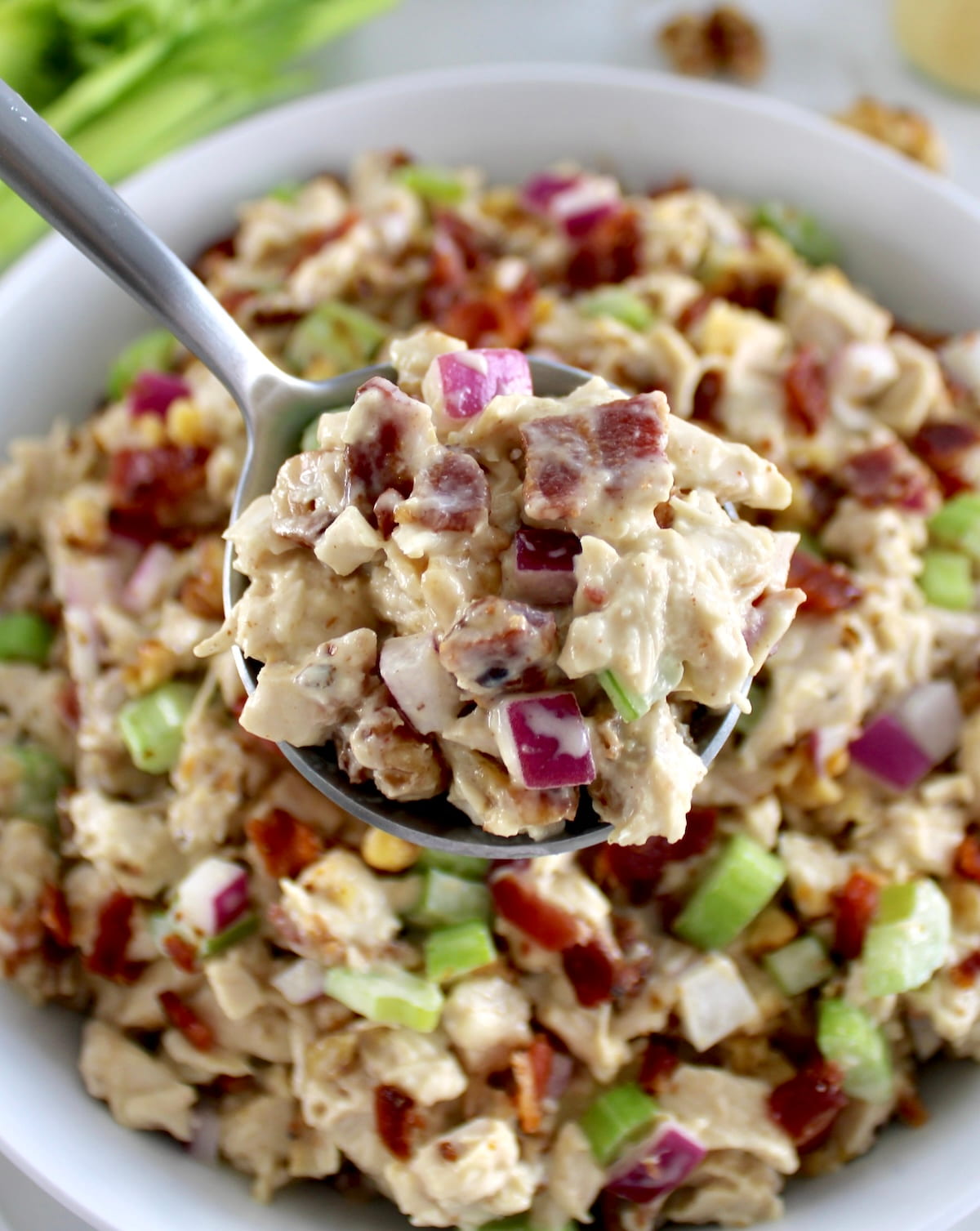Bacon Honey Mustard Chicken Salad in spoon held up over white bowl