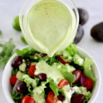 Keto Avocado Ranch Dressing being poured over salad