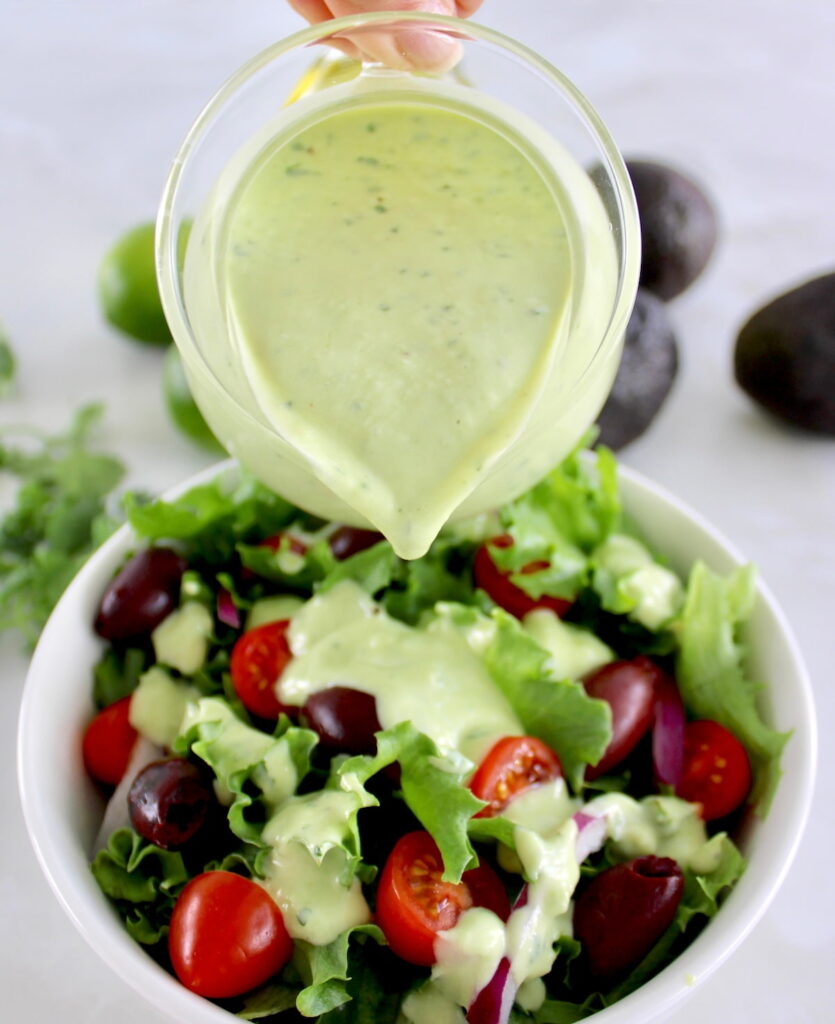 Keto Avocado Ranch Dressing being poured over salad