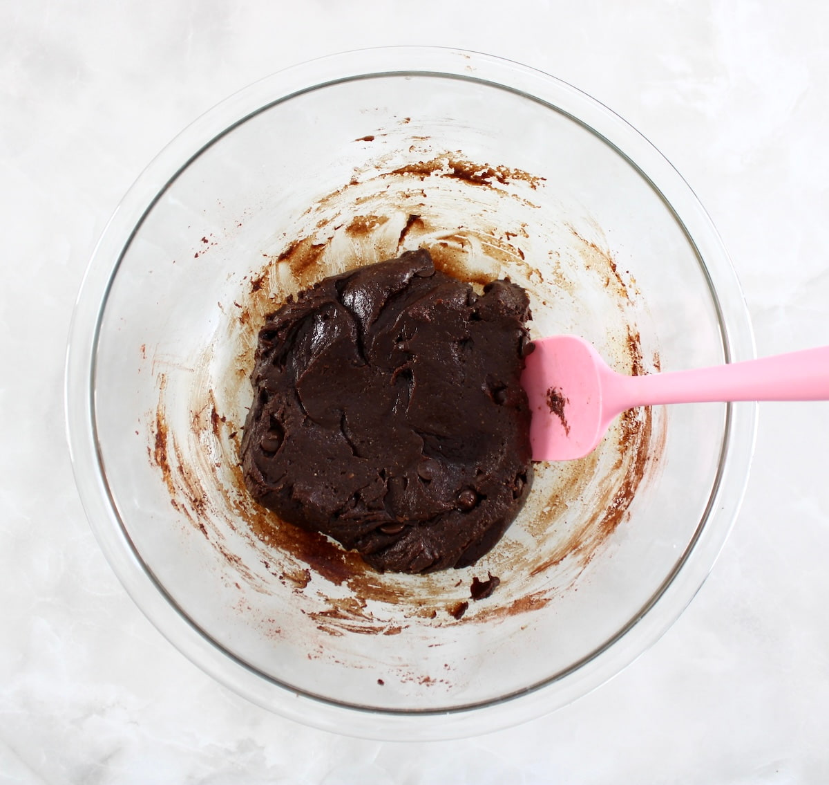 Keto Chocolate Almond Butter Cookies batter in glass bowl with pink spoon