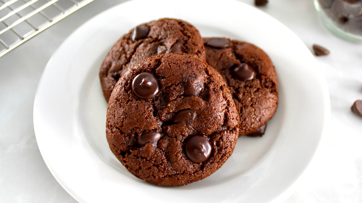 3 Keto Chocolate Almond Butter Cookies on round white plate