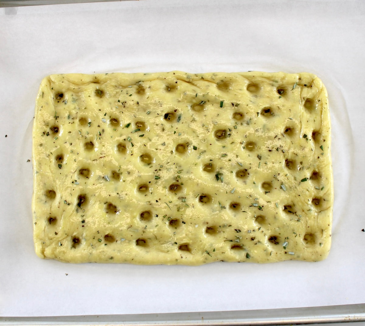 Keto Focaccia Breadsticks dough on baking sheet with parchment paper