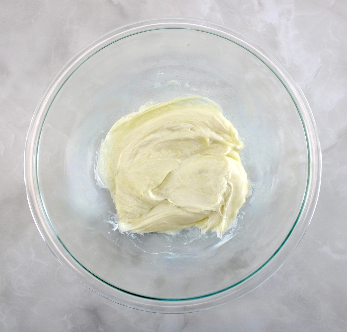 melted mozzarella cheese in glass bowl