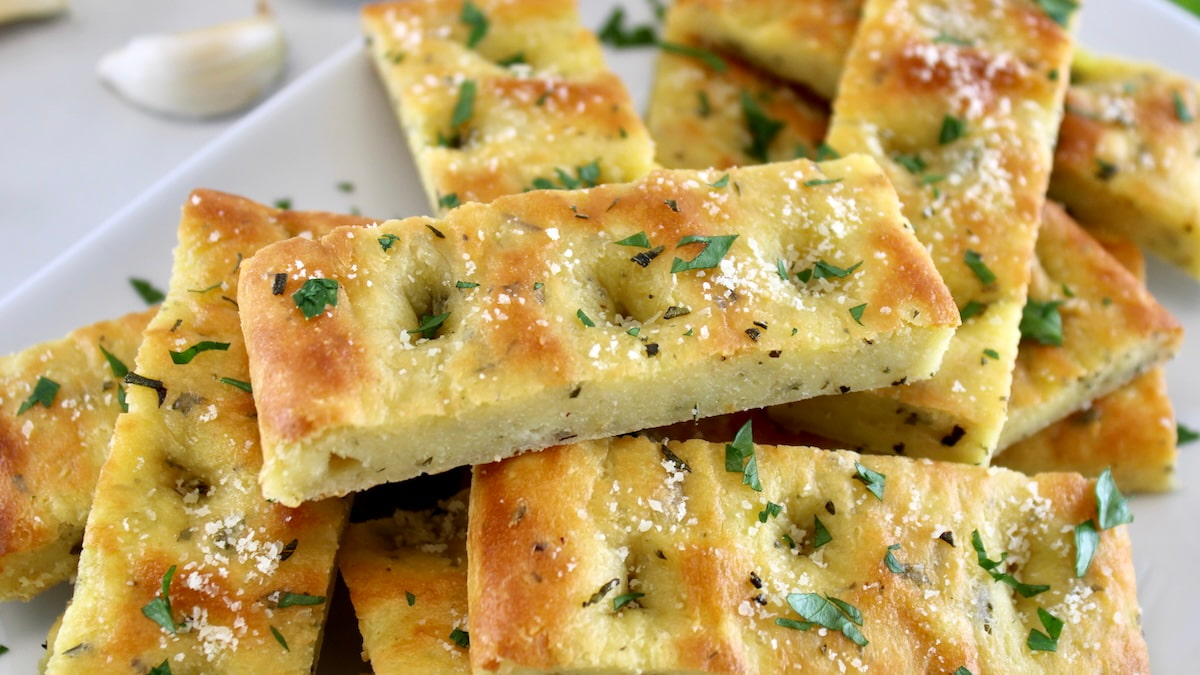 Keto Focaccia Breadsticks stacked on white plate