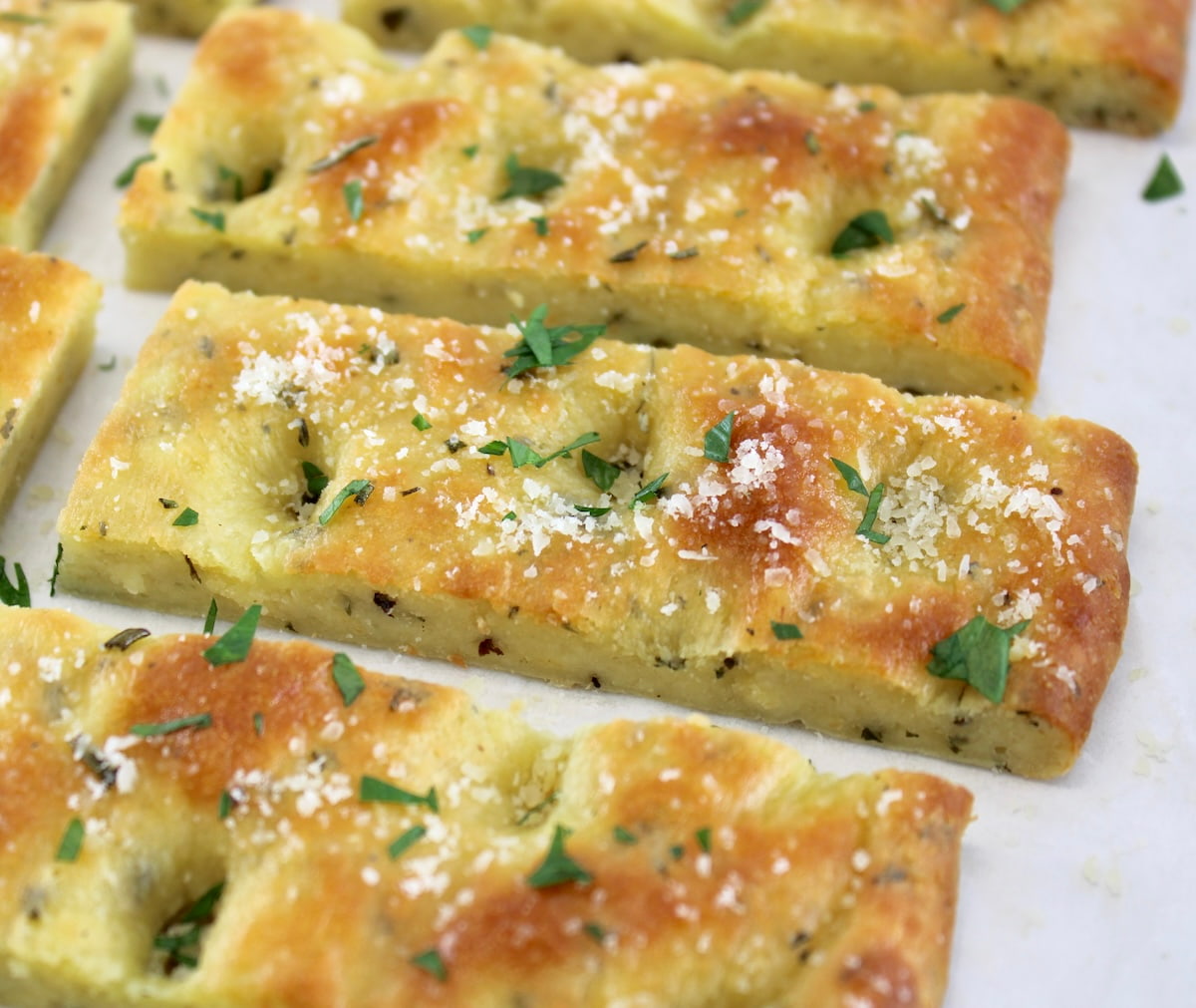 Keto Focaccia Breadsticks on white parchment paper