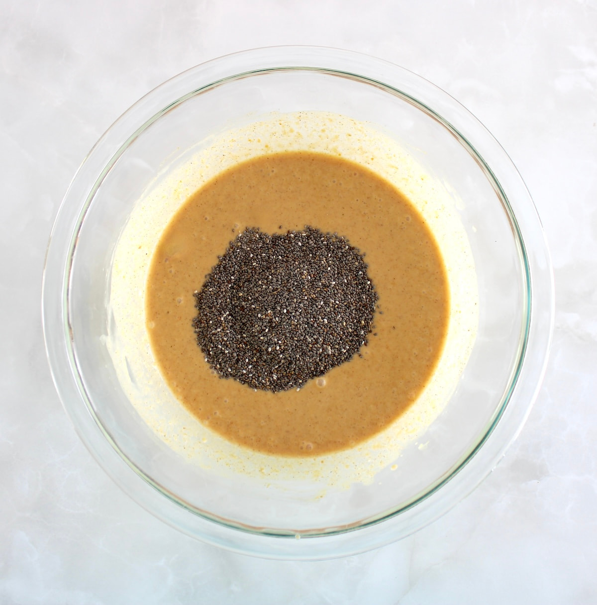 Pumpkin Chia Pudding in glass bowl with chia seeds on top