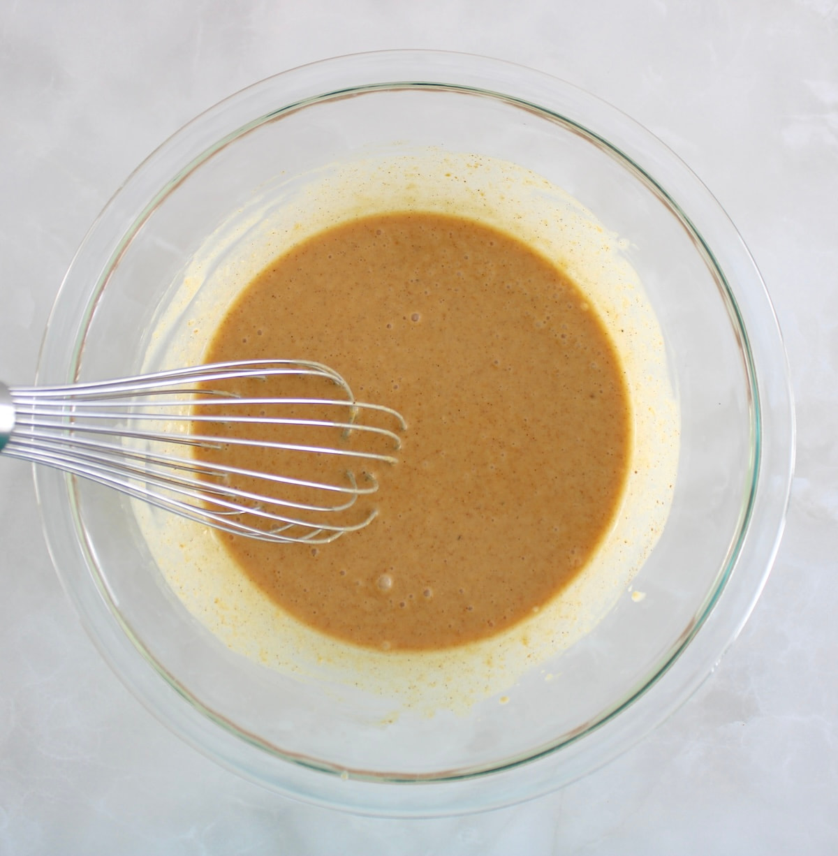 Pumpkin Chia Pudding in glass bowl with whisk