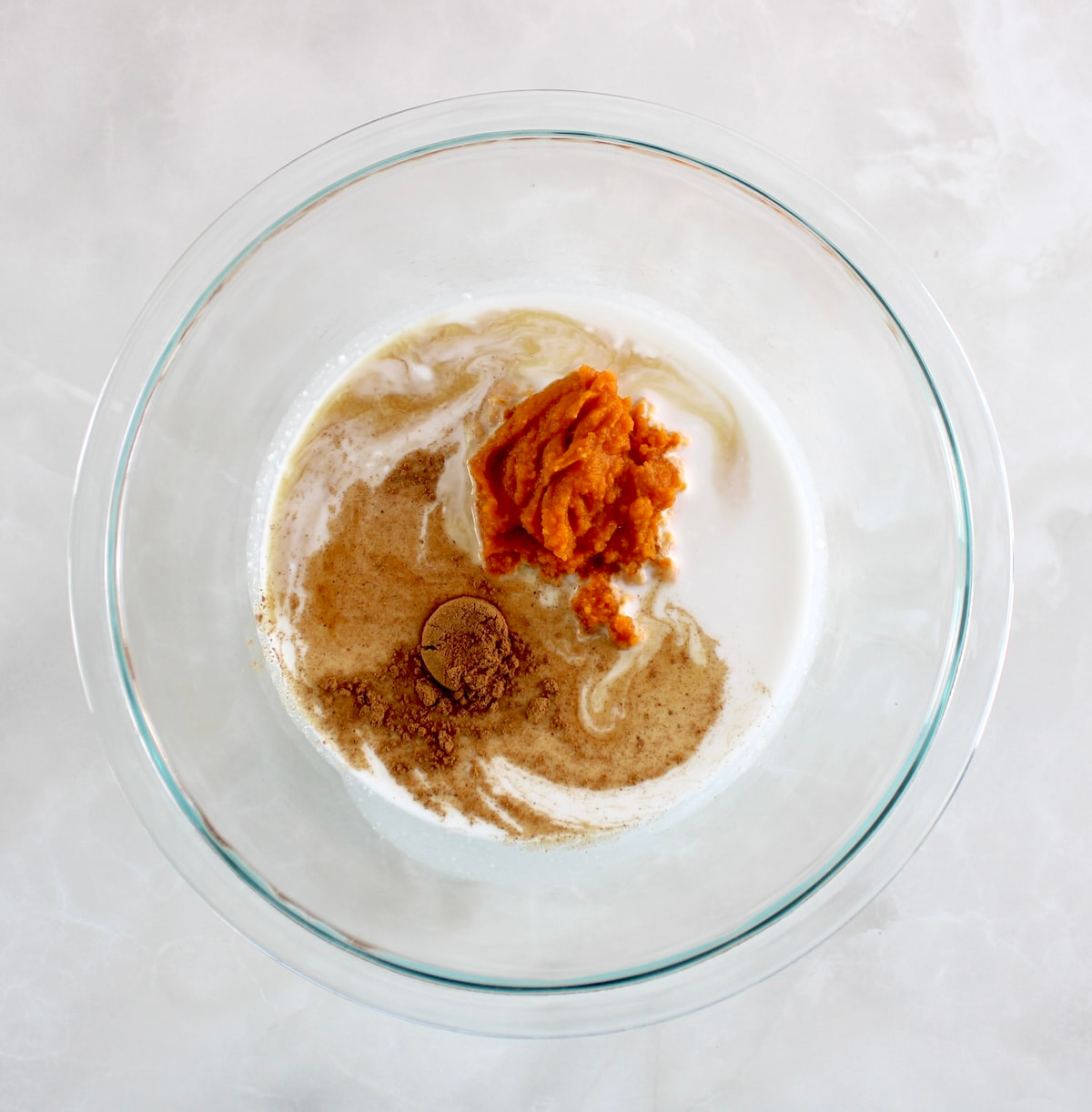 Pumpkin Chia Pudding ingredients in glass bowl unmixed