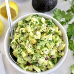 Avocado Egg Salad in white bowl with spoon on side