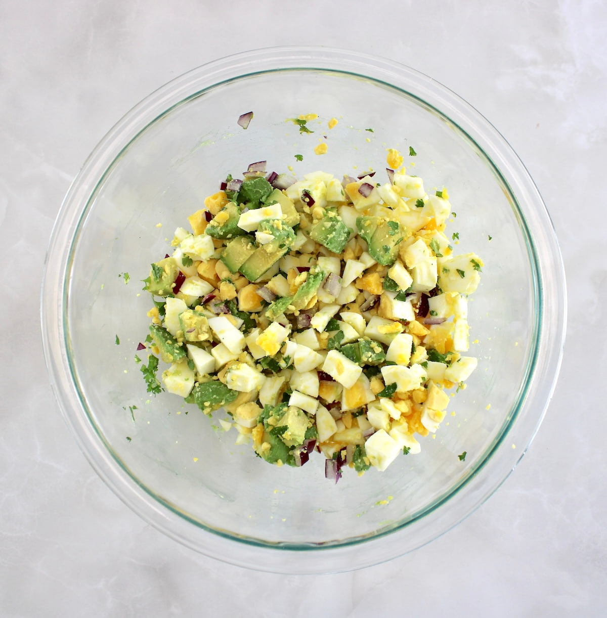 Avocado Egg Salad ingredients in glass bowl