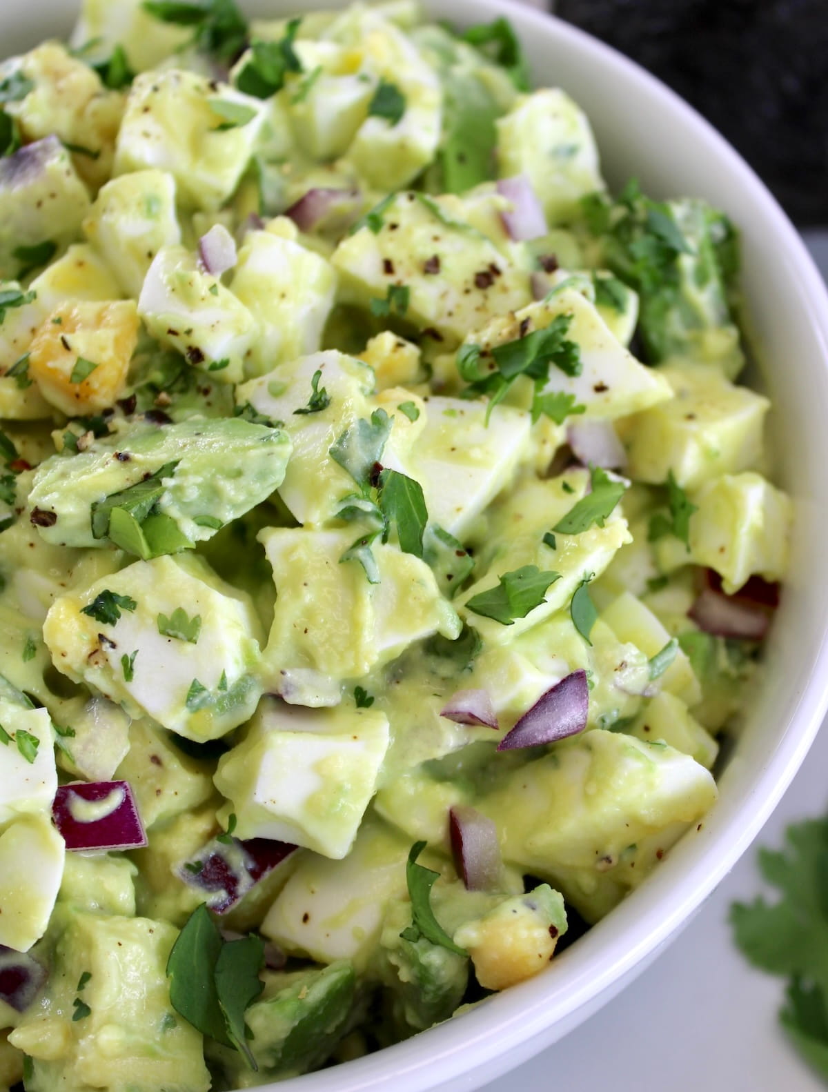 closeup of Avocado Egg Salad in white bowl