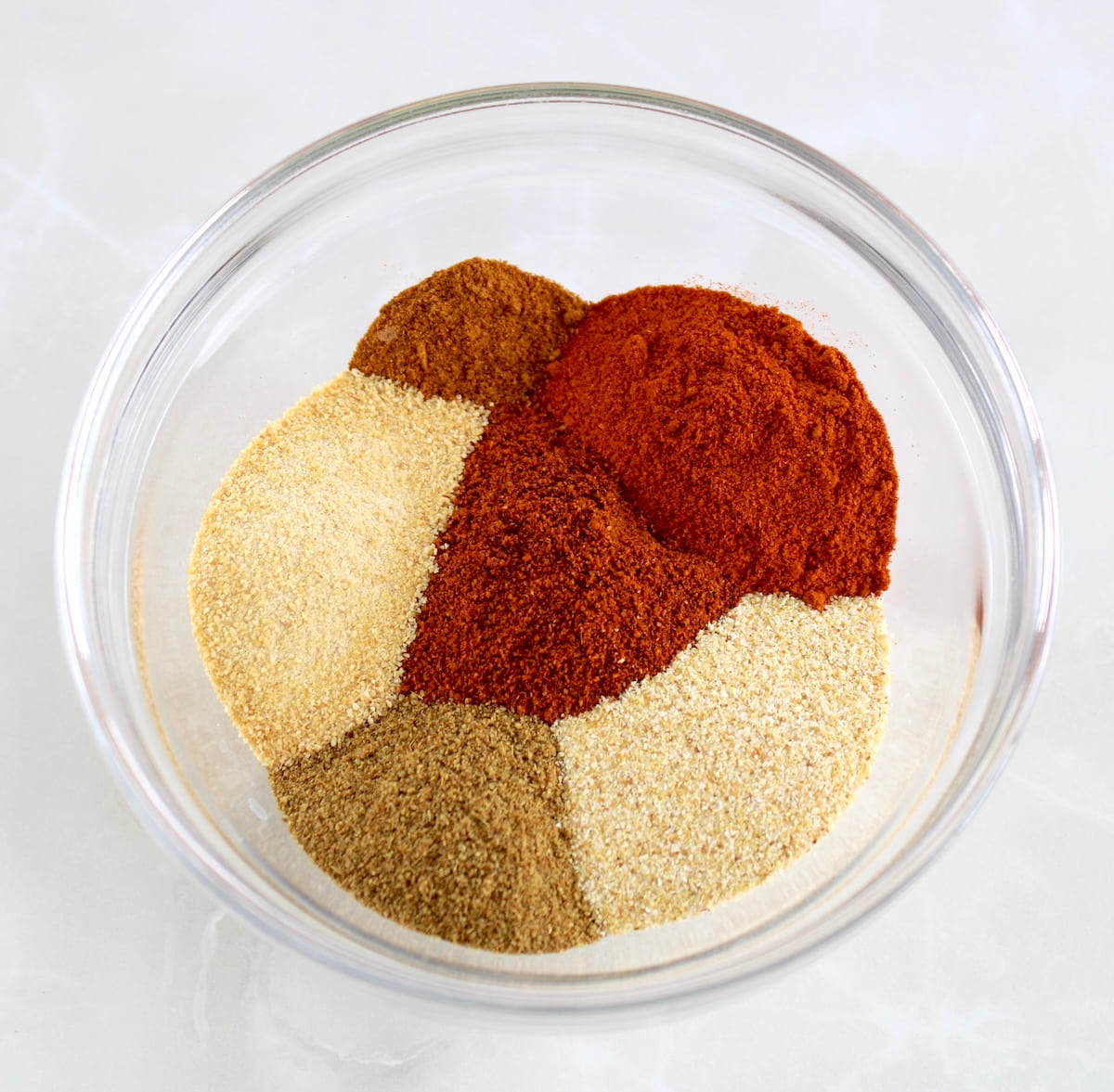 Homemade Chili Seasoning spices in glass bowl unmixed
