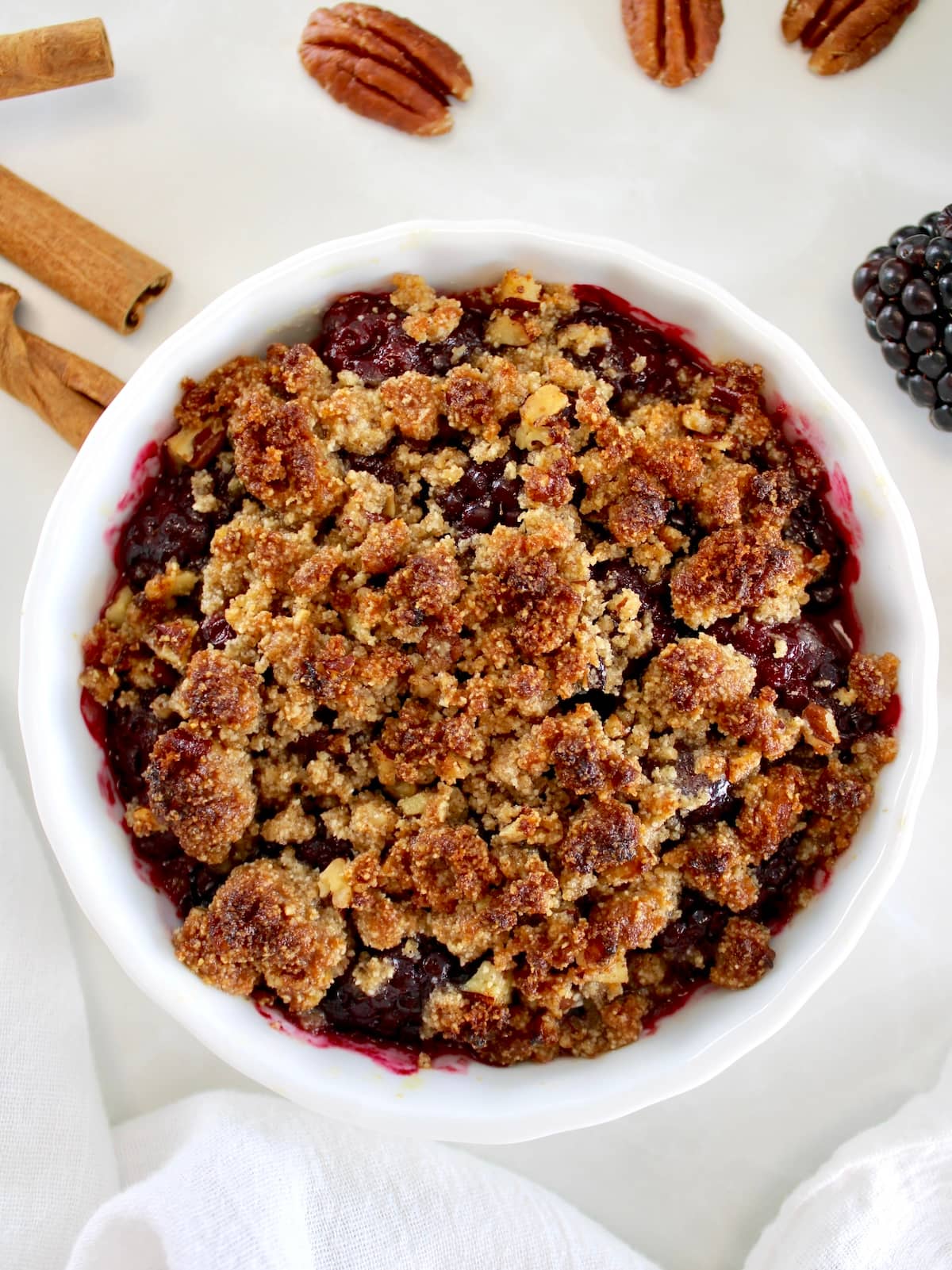 overhead view of Keto Blackberry Crumble in white ramekin